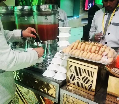A guest enjoying our live chaat counter at a corporate event in Gurgaon. Interactive food stations are a fantastic way to add some fun and flavor to professional gatherings.