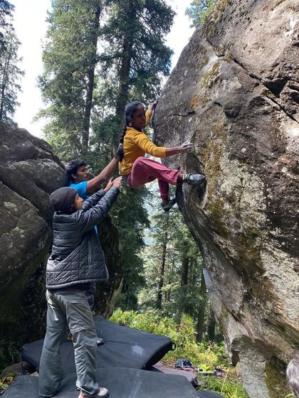 A young climber gets a helpful boost from her friends while bouldering in Sethan. Our community is all about teamwork and supporting each other, no matter your age.