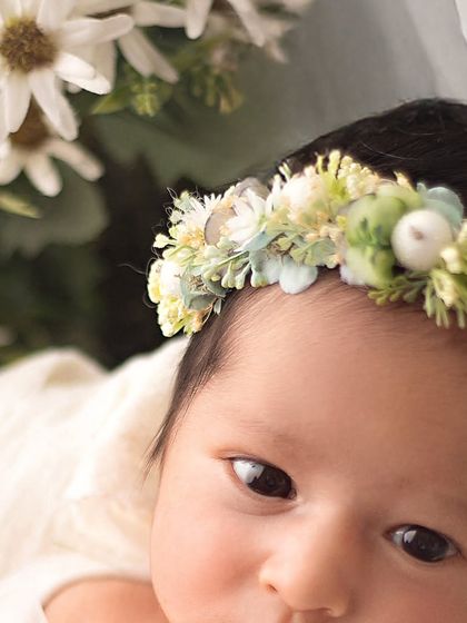 This little one opened her eyes for a moment, allowing me to capture this detailed shot of her beautiful eyes and delicate floral crown.