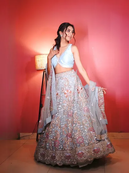 A full-length shot that captures the elegance of the floral lehenga.