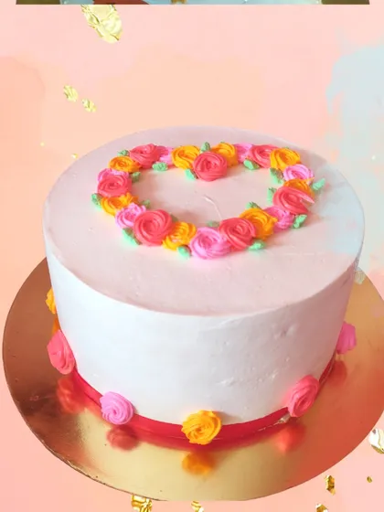 This cake shows that you can have a floral theme without fresh flowers. I used careful piping skills to create a heart-shaped wreath of colorful rosettes, resulting in a simple, elegant, and heartfelt design.