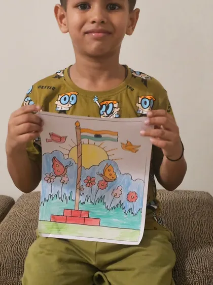 Happy Independence Day! A young student proudly holds up his drawing of the Indian flag waving in a beautiful garden.