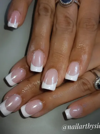 A classic French manicure on square-shaped nails with a pearlescent finish for an extra touch of class.
