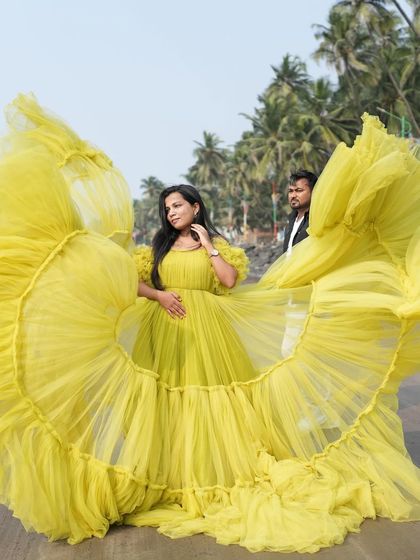 A dramatic shot of the yellow gown with its trail fanned out, showcasing its "flying gown" potential for creative photoshoots.