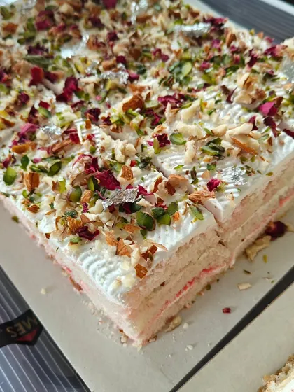 A perfect example of our East-meets-West philosophy. This is our signature Rasmalai pastry, featuring soft, cardamom-spiced cake layers, light cream, and garnished with pistachios, almonds, and delicate rose petals.
