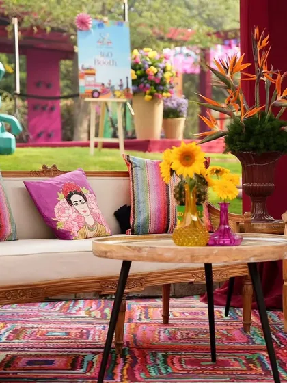 It's all in the details. For this carnival Haldi, we curated cozy seating areas with colorful rugs, Frida Kahlo-themed cushions, and bright floral arrangements in unique vases.