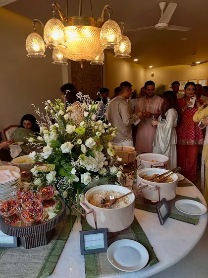 Guests mingling and enjoying the food at our buffet station, which is designed to be both beautiful and functional.