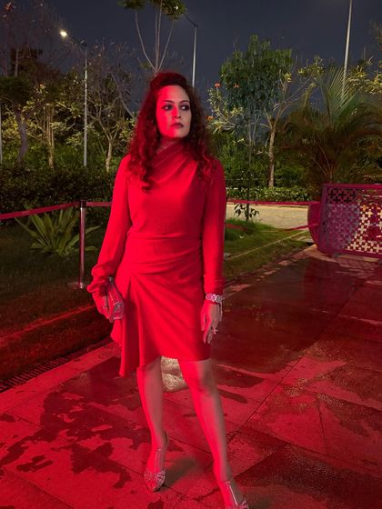 A post-show shot in a powerful red dress. The color red communicates confidence and energy, and I teach clients how to use color psychology to their advantage in my styling sessions.