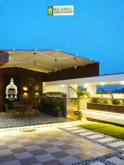 A wide view of the Palam Vihar project, showing the relationship between the covered seating area and the larger open terrace.