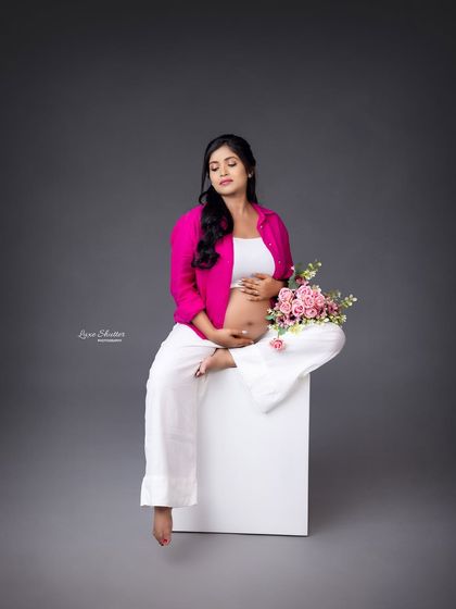 Adding a bouquet of flowers brings a touch of softness and femininity to this modern, casually styled studio portrait.