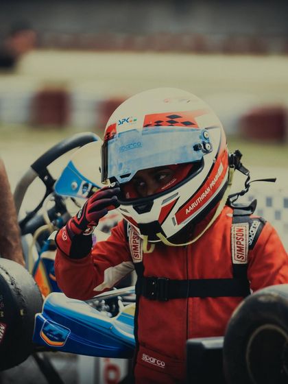 A close up of a young driver, focused and ready.