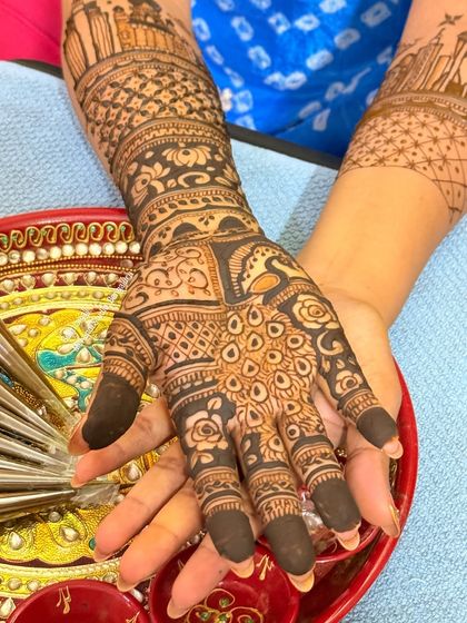 A close-up of the palm, showing the intricate details of the peacock and floral patterns.