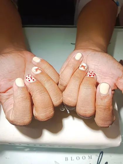 I absolutely loved bringing this client's cute idea to life. This custom set features hand-painted Mickey and Minnie Mouse details with polka dots on a nude base. No matter the request, I am here to create your dream nails.