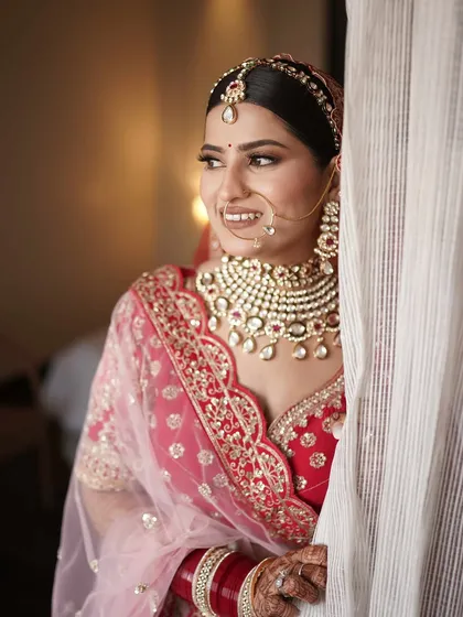 A candid peek of the bride. Her soft smile and glowing makeup create a timeless and beautiful bridal portrait.