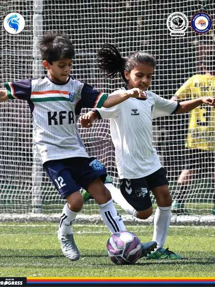 A boy and a girl compete for the ball, highlighting the co-ed nature of our younger age group leagues.