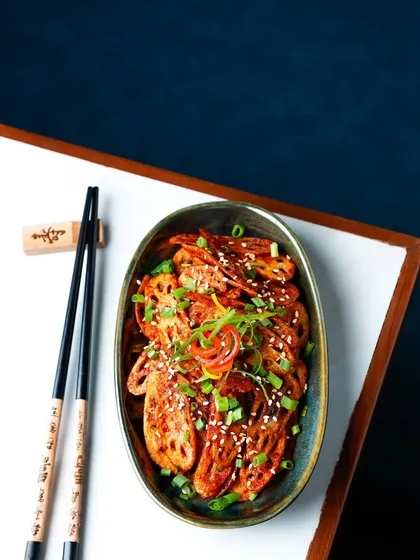 I use creative composition and moody lighting to make dishes stand out. For these honey chilli lotus stems, the framing and dramatic light highlight the glistening glaze and crispy texture, creating a truly memorable image.