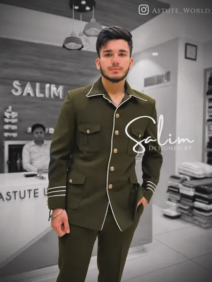 A modern take on a classic safari suit, tailored as a Jodhpuri. This olive green ensemble features white piping and striped details on the cuffs for a sharp, contemporary feel.