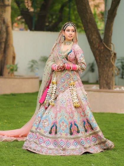 Pastel pink dreams for our perfect morning bride. The soft colors of her lehenga and makeup are ideal for a day wedding.