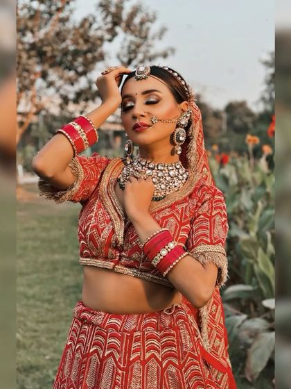 A dreamy, artistic shot of the bride in her red lehenga.