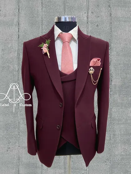When you can't find the perfect suit, you get a masterpiece created. This maroon three-piece suit is tailored to perfection for a sharp and elegant silhouette.