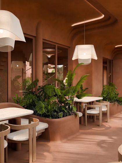 The dining area features simple wooden furniture and soft, fabric-like pendant lights, creating a calm and inviting atmosphere for guests.