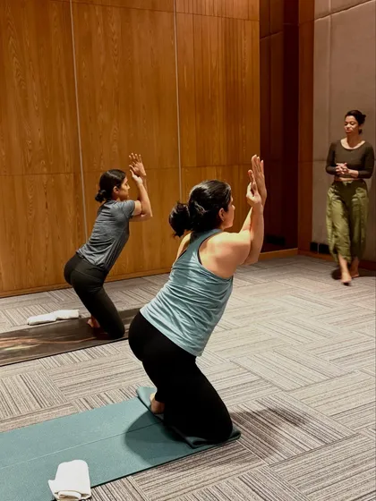 Observing students as they hold Garudasana (Eagle Pose) arms. This allows me to see where they need support and offer verbal cues to refine their posture.