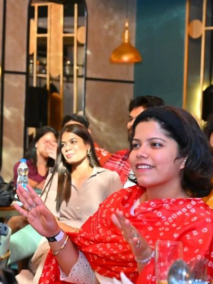 A participant in a beautiful red bandhani dupatta, perfectly fitting the desi vibe of our Bollywood nights.
