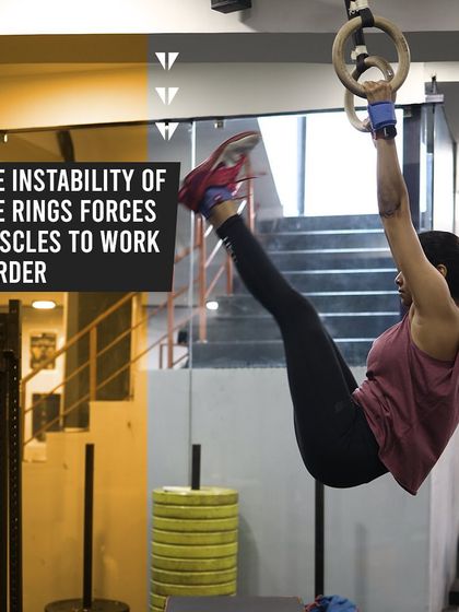 The instability of the rings is what makes them so effective. This athlete is performing a leg raise, engaging her core and upper body simultaneously to control the movement.