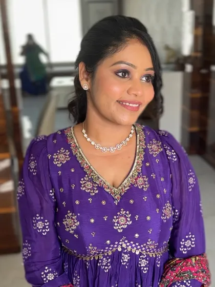 A lovely soft glam look on a mature client. The purple eyeshadow is blended softly to complement her outfit, paired with a natural lip color for an elegant finish.