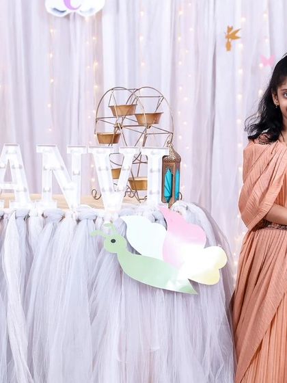 A charming 'Little Man' themed first birthday party, with a sophisticated black and white color scheme, mustache props, and a stylish backdrop, perfect for a dapper celebration.