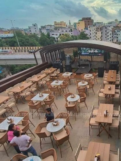 Another view of the retractable roof system, showing its integration with the surrounding architecture and the city view.