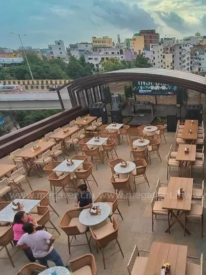 Another view of the retractable roof system, showing its integration with the surrounding architecture and the city view.
