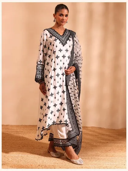 This black and white printed kurta set is a bold and modern choice. The geometric print and contrasting borders make it a true statement piece.