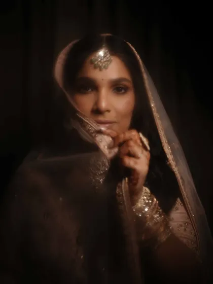 A truly timeless bridal portrait. For this look, I used soft golden hues on the eyes to complement her pastel pink lehenga. The focus was on creating luminous, glowing skin that looked dreamy and perfect under the soft lighting, paired with a classic half-up hairstyle.