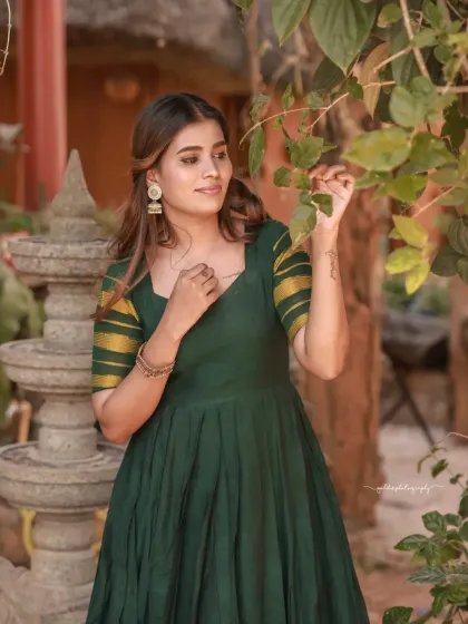Portraits of a model in a green dress, captured in a traditional house setting. The warm, earthy tones of the location complement the outfit and create a peaceful, grounded mood.