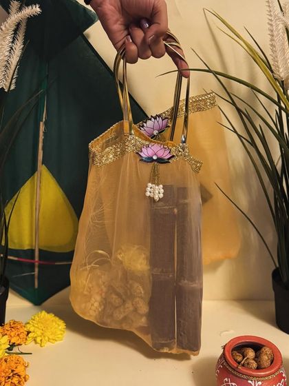 A beautiful net potli bag in gold, filled with Sankranti goodies. An elegant and lightweight option for return favors.