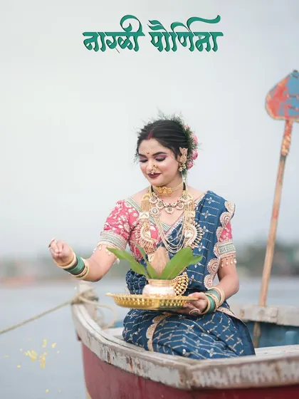 A beautiful shot for Narali Purnima, with the model in a boat performing the traditional ritual of offering a coconut to the sea.