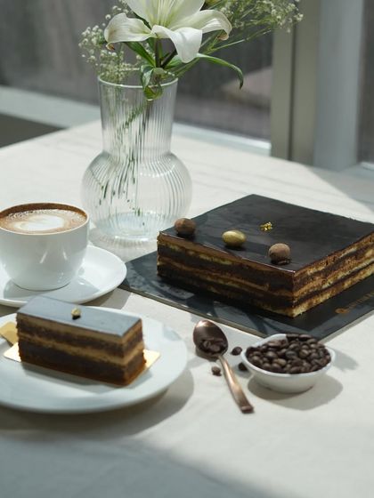 A beautifully composed shot of my Opera Cake, highlighting its intricate layers and glossy chocolate top.