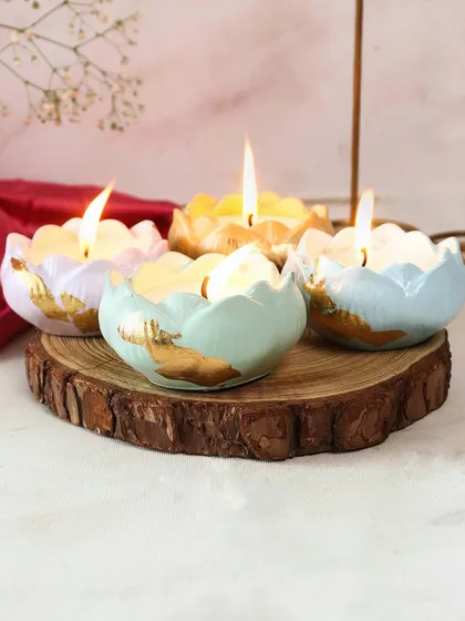 Our cute Lotus Jars are the perfect Diwali gift. This shot captures them on a rustic wood slice, highlighting their handmade charm.