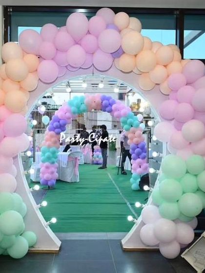 This double balloon arch in pastel colors created a beautiful and grand entrance for an enchanted forest party, leading guests into the main celebration area.