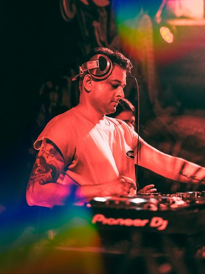 In the mix during a stomper of a set at Hilltop, Goa. The rainbow lens flare adds a touch of unexpected magic to the moment.