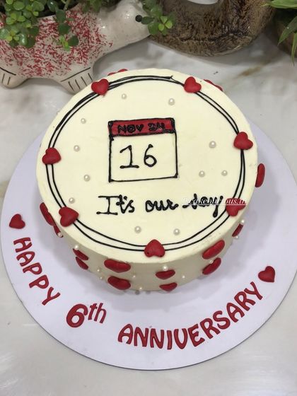 A beautiful way to mark your special day. This anniversary cake features a hand-drawn calendar with the significant date circled, surrounded by red hearts. A sweet and personal design.