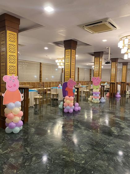 A different angle of the Peppa Pig party, showing the character pillars in the banquet hall.