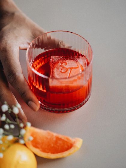 The perfect weekend toast. This cocktail features a custom-stamped ice cube with my 'ST' logo, a small detail that adds a touch of personalized luxury.