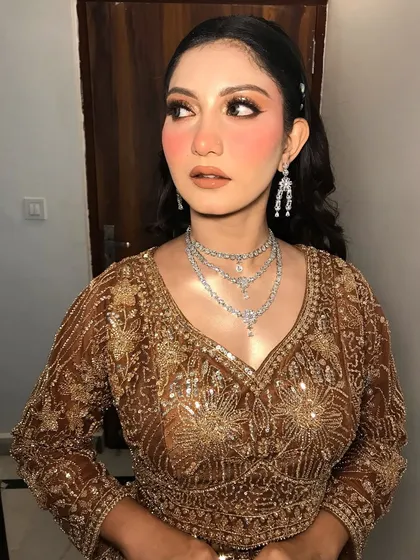 This client is a "Golden Girl" in her bronze-gold outfit, styled with a layered American diamond necklace.