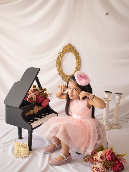 A playful pose by the piano. I always encourage kids to be themselves, and her fun personality shines through in this shot.