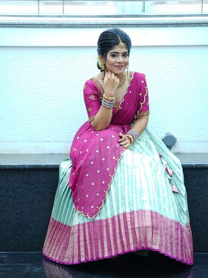 Nothing makes me happier than dressing sisters for their special moments. I designed these matching turquoise and purple Langa Voni outfits for a half saree function, ensuring they both looked coordinated yet unique.