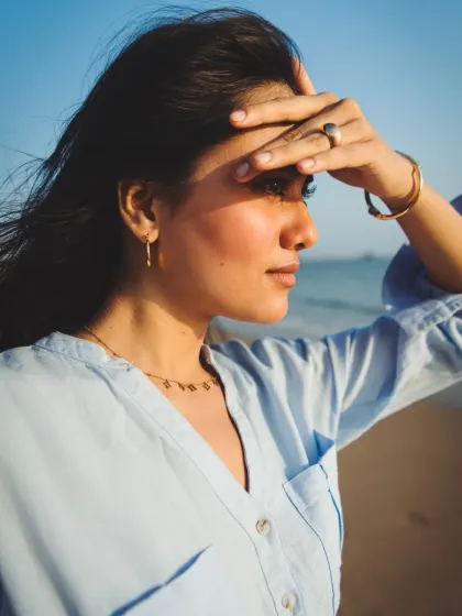A classic, candid beach pose. This shot feels natural and unstaged, like a captured memory from a day by the sea.