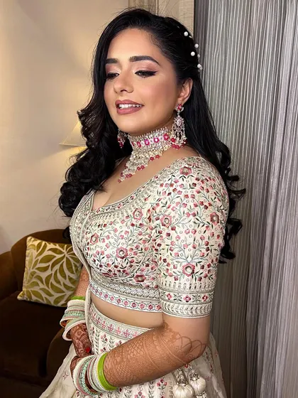 Another angle of this stunning engagement look. The soft waves in her hair, adorned with pearls, complete the elegant and confident vibe.