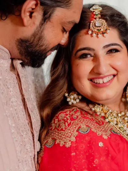 A close-up of this bride's reception look. Her happiness is infectious. The makeup is soft yet glamorous, with defined eyes and a warm smile, perfect for celebrating with her partner.